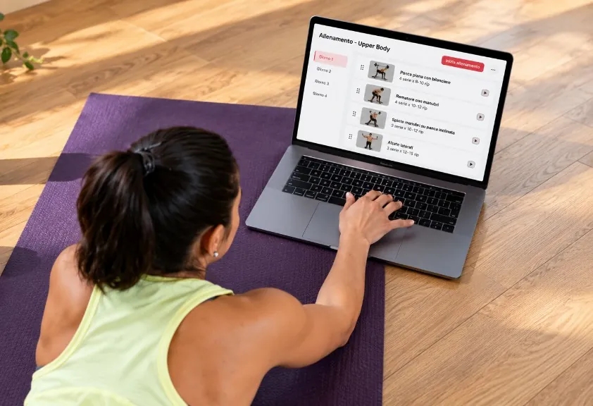 Athlet zu Hause auf der Matte folgt dem Training auf dem Laptop.